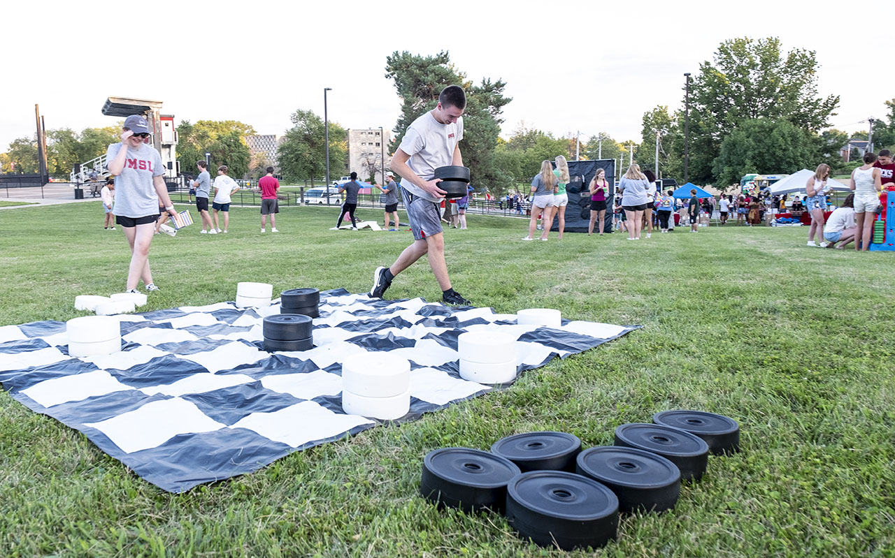Students playing on a giant checker board