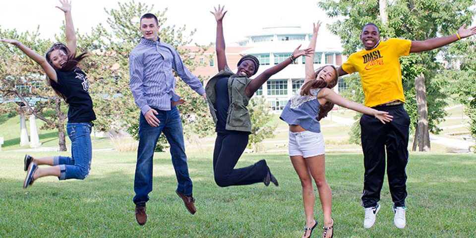 Five students jumping