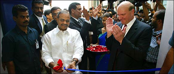 Steven A. Ballmer, right, claps as the chief minister of Andhra Pradesh, Y. S. Rajasekhar Reddy, opened the Microsoft center.