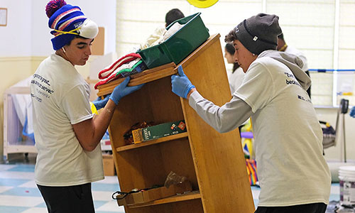 2 students moving furniture