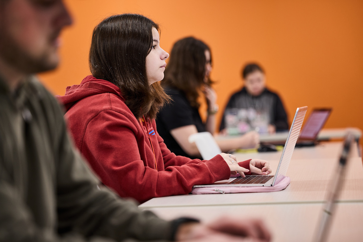 A row of students seated in a classroom