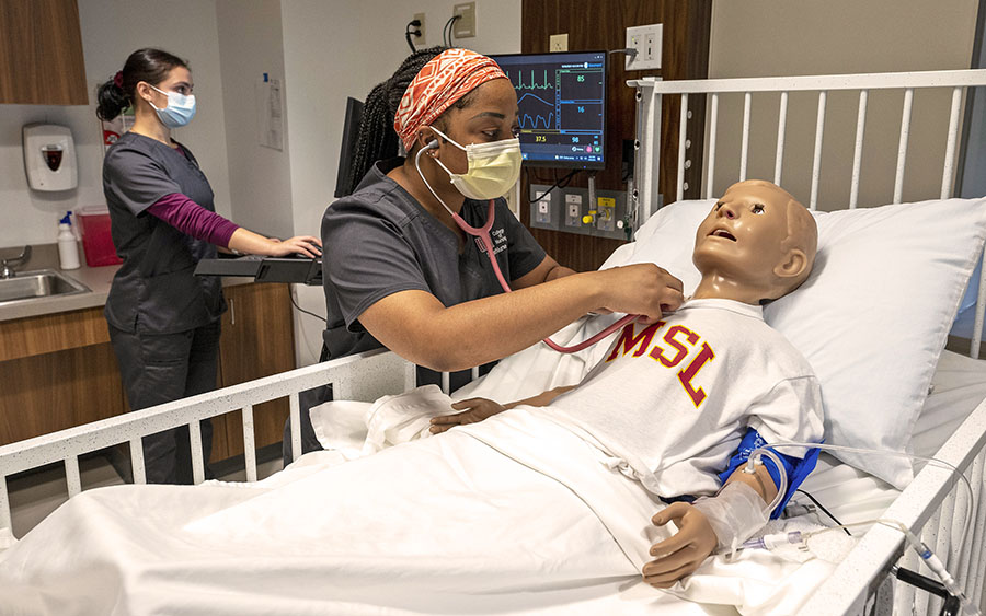 two nursing students in the simulation lab