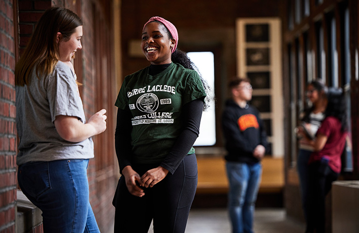 students talking in a hallway