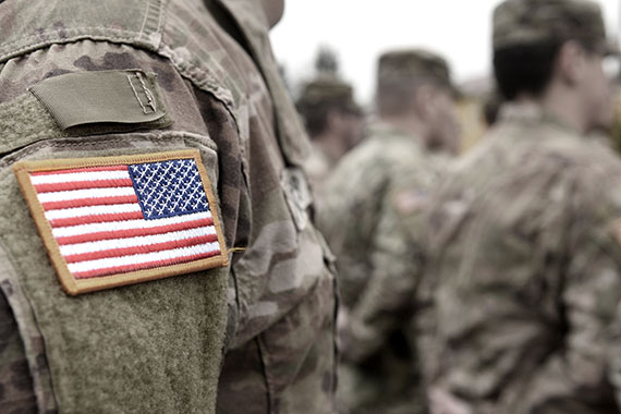 close up of american flag patch on military uniform