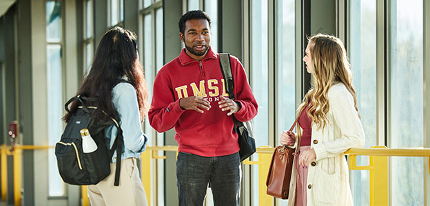 3 students talking on the Bridge