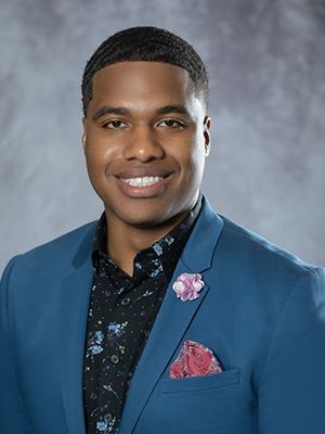Headshot of LaVell Monger in front of a gray backdrop.