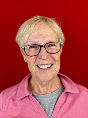 Close-up photo of Terry Freerks in front of a red background.