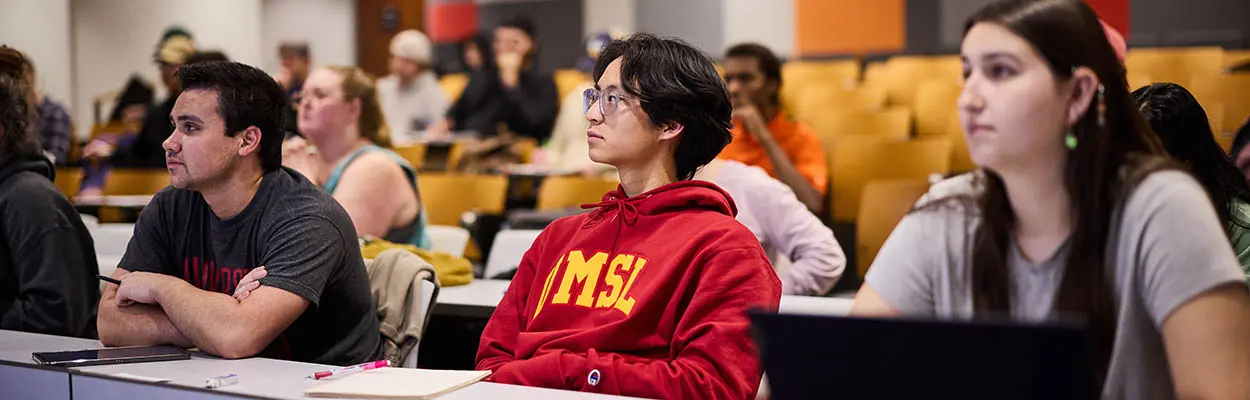 students in a classroom listening to a professor