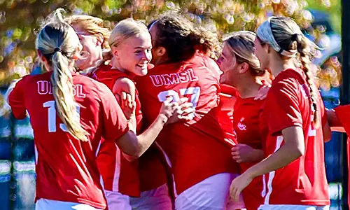 womens sports team in a happy huddle after winning a match