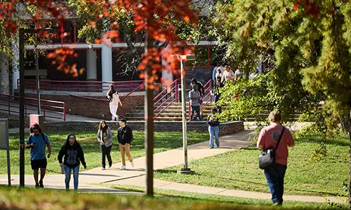 students walking on campus in front of the science complex