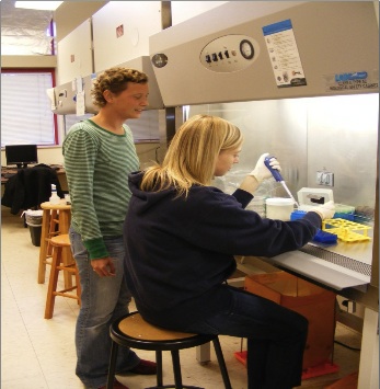 Student and professor work on experiment