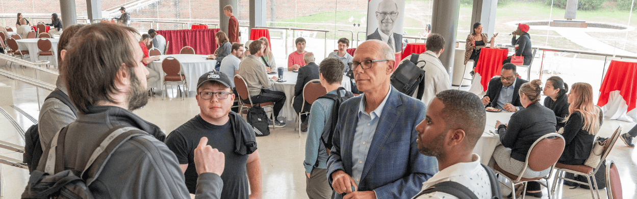 group of guys talking at a conference