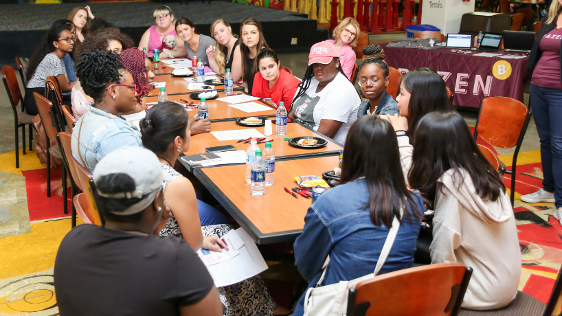 students around a table in discussion