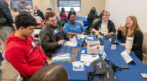 a group of people talking at a table
