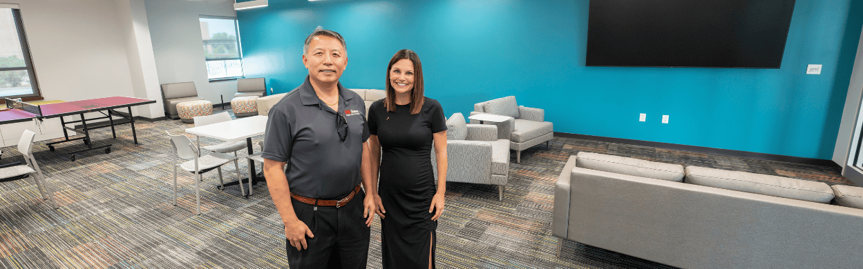 man and woman standing in a classroom