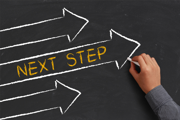 Chalkboard illustration featuring three directional arrows with "NEXT STEP" written in yellow.