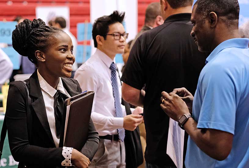 Student speaking with career fair representative