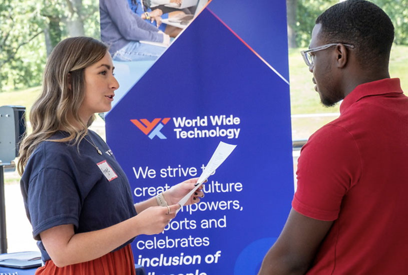 Student speaking with representative at career fair