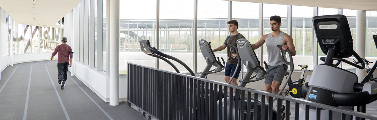 People using the treadmills and walking on the indoor track