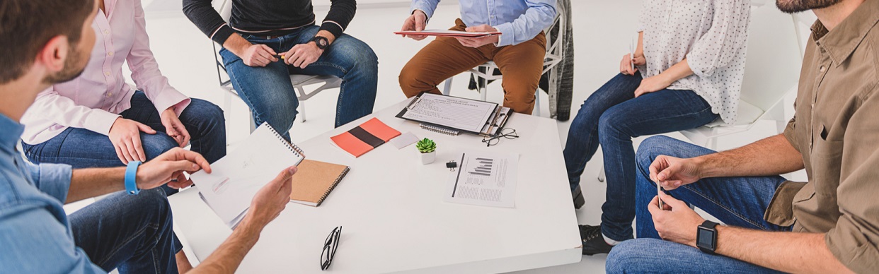 people sitting around a table at a meeting