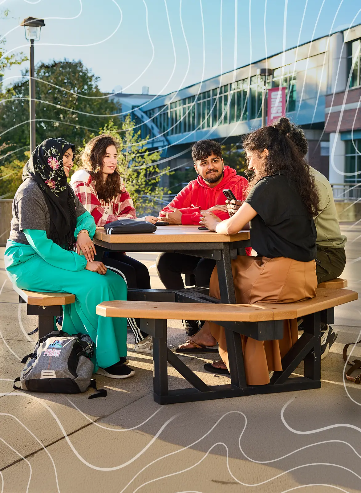 two UMSL students in conversation while walking down sidewalk