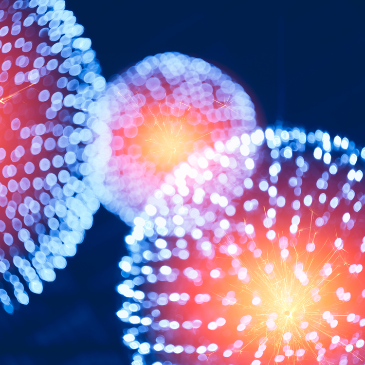 Abstract illustration of colorful light orbs with a glowing effect on a dark background.