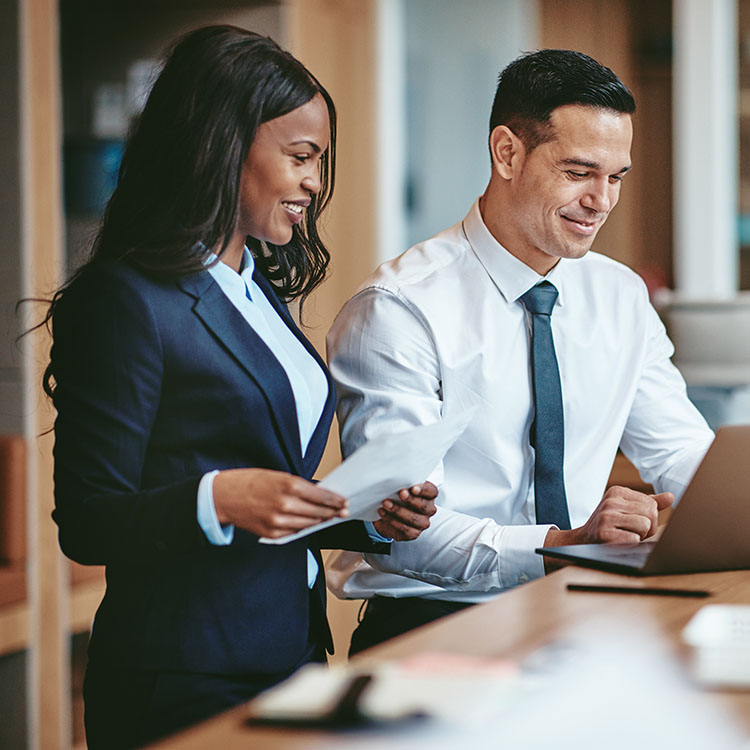 two people working at a laptop