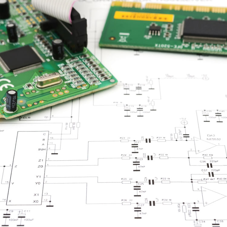 Close-up of electronic circuit boards and schematics, showcasing components and layout for a technical design.
