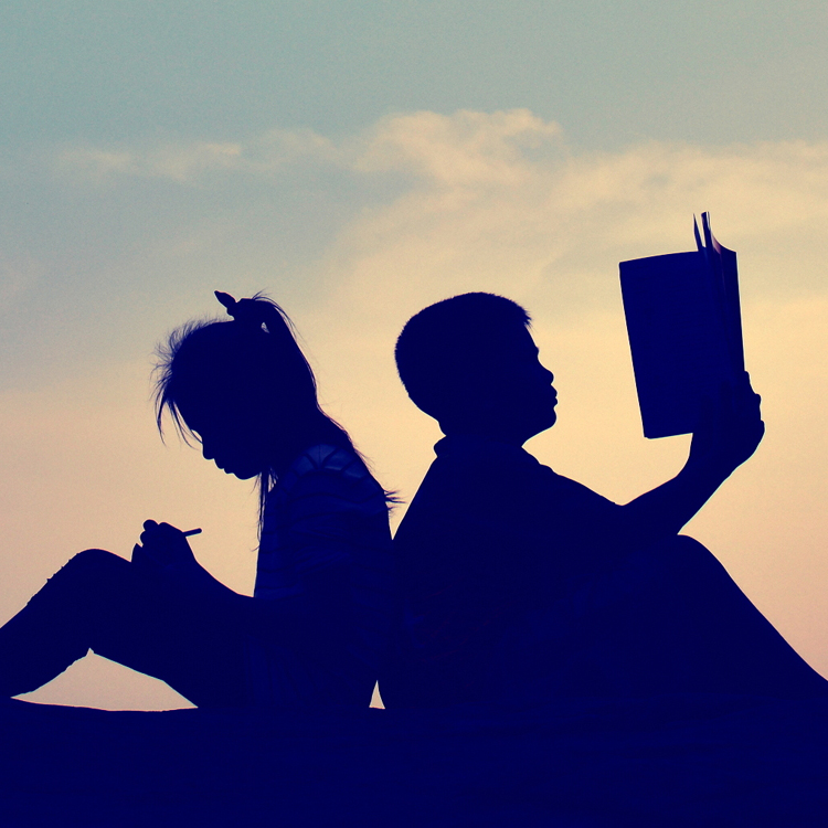 silhouette of children reading