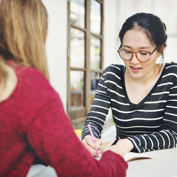 two students reviewing their academic studies