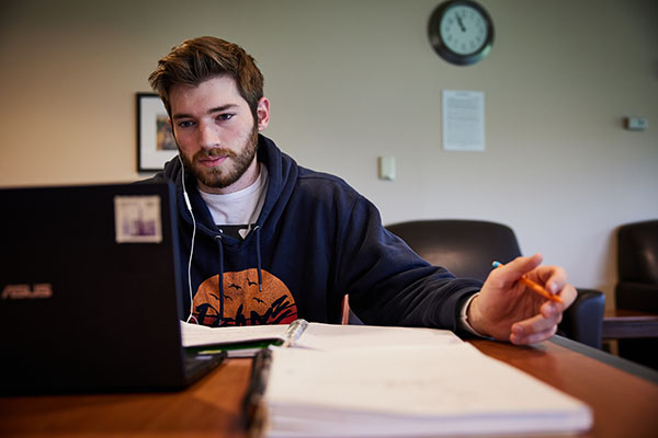 student working at a laptop