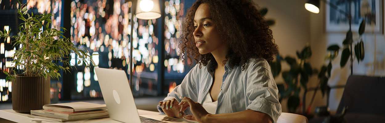 female student working on a laptop at home