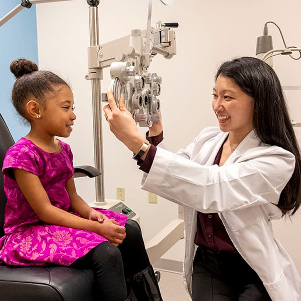 optometry professional with child patient