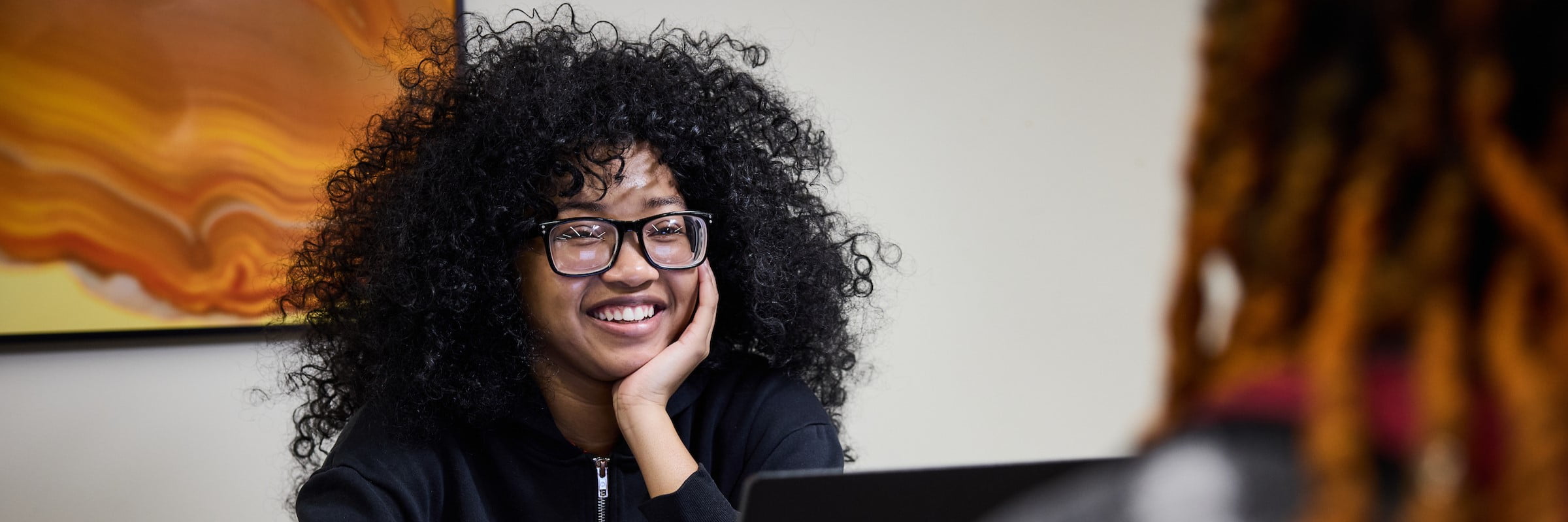 A student in conversation with a peer mentor
