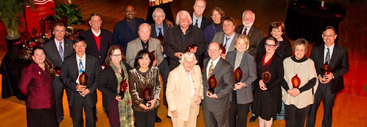 Group of people on stage with awards