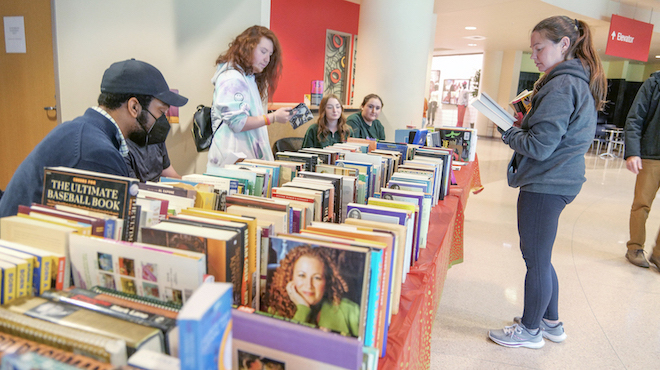 Professor Kate Watt checking out the Litmag book fair offerings