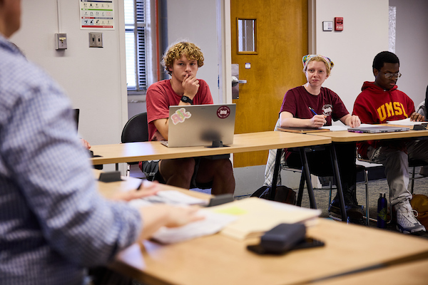 Students in class, excited to learn