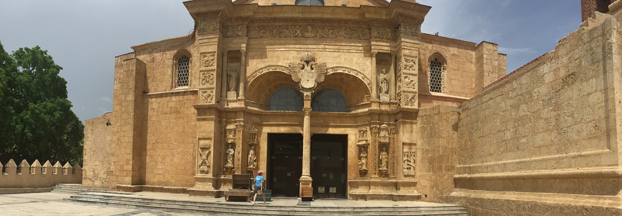 Large shrine is shown in a wide shot with a person walking up to the door