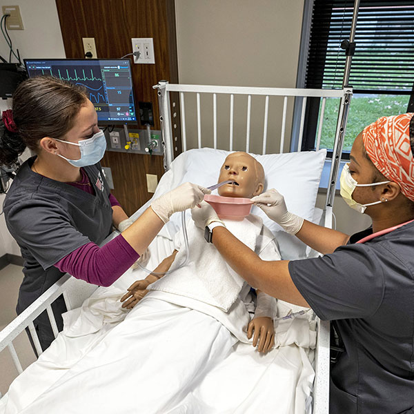 nursing students with child simulation patient