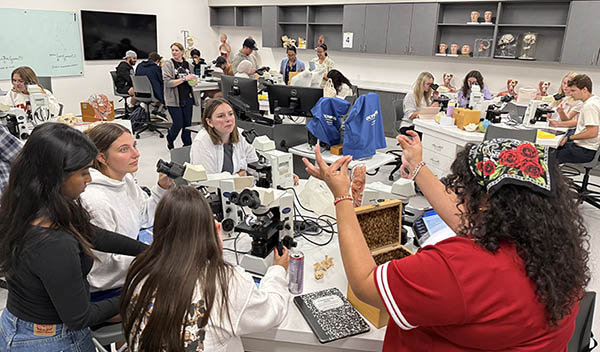 New lab space with students gathering around large tables