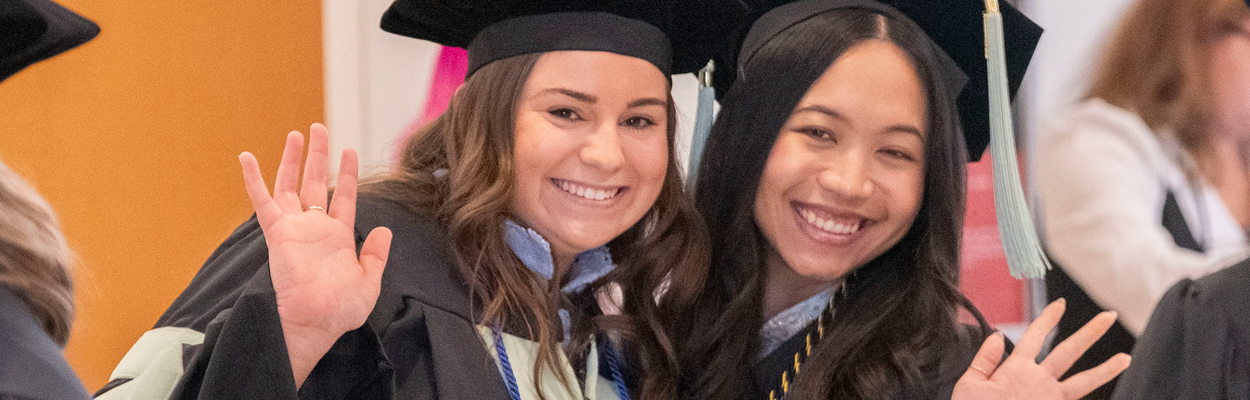 Two graduates with champagne bottle