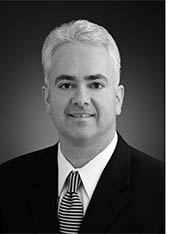 Black and white photo of Dr. McGreal wearing a suit