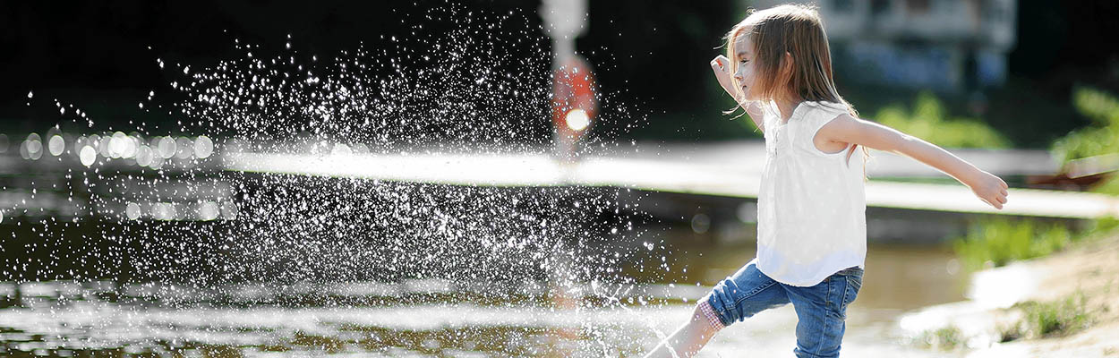 young child kicking water