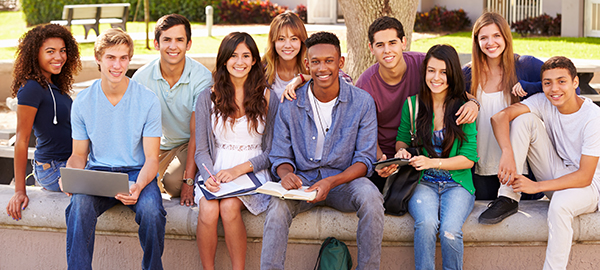 students sitting on cement surface