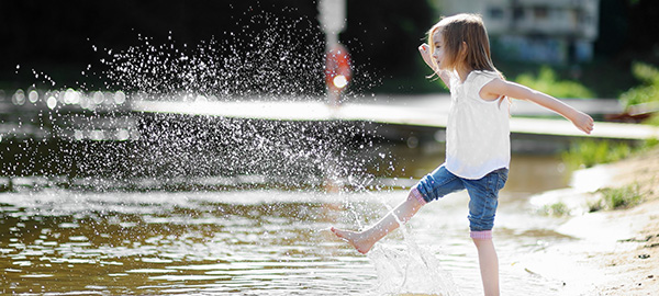 young girl kicks water