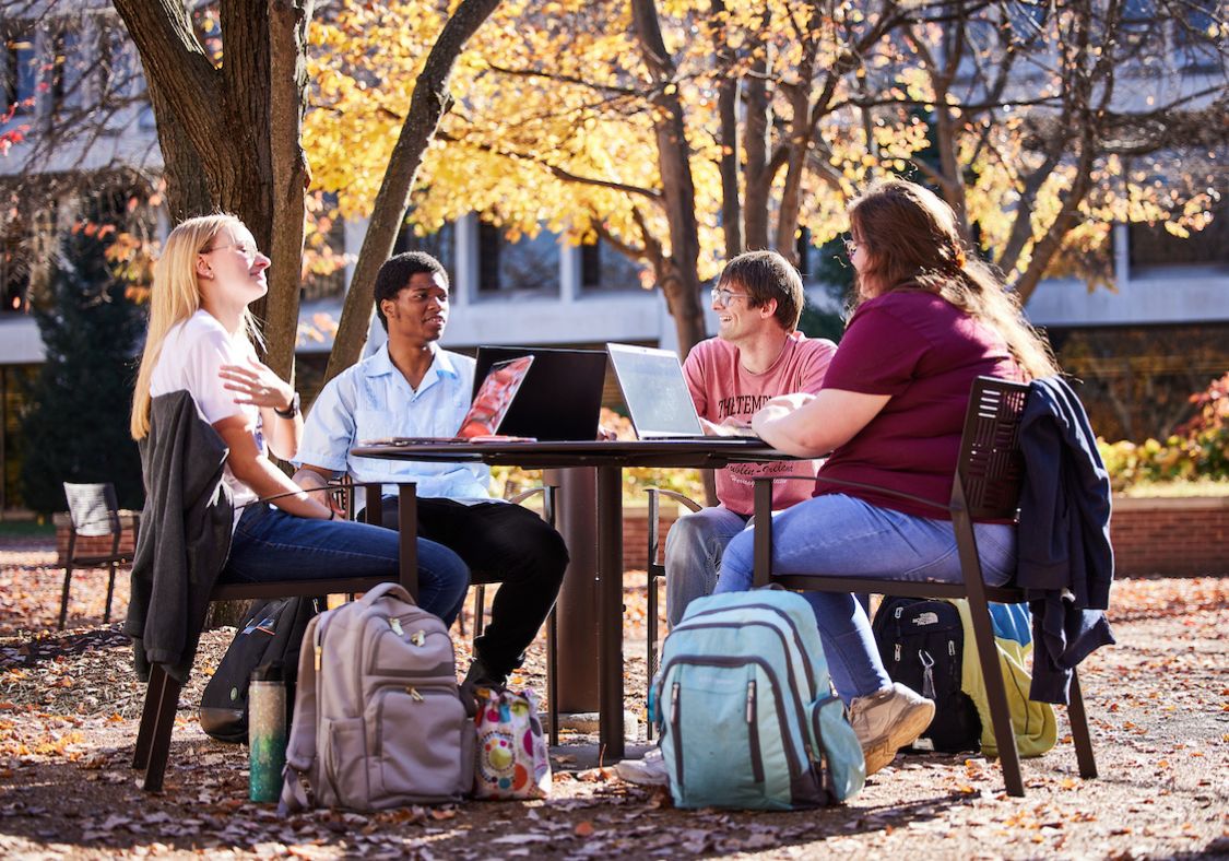 Students sitting around patio table