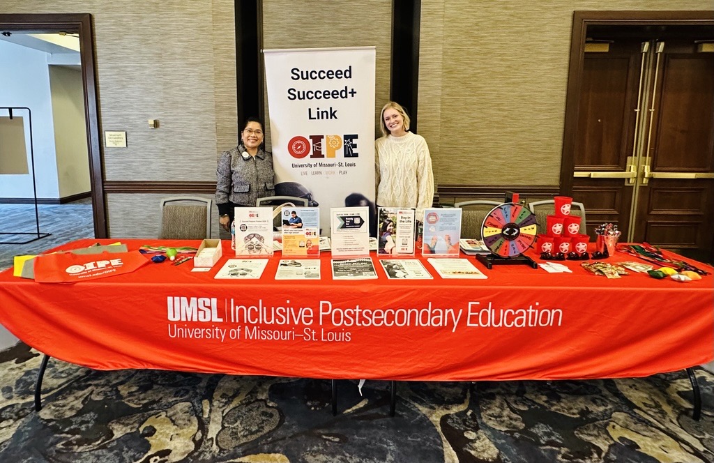 Two females by a red exhibit table