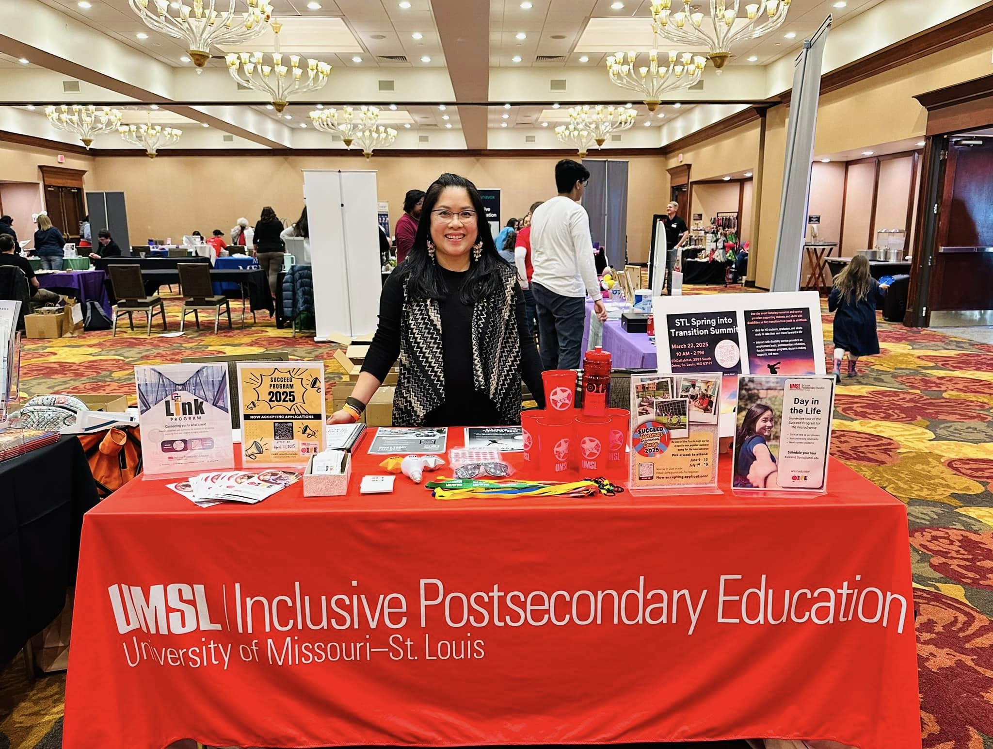 OIPE red table with info and swag about college programs