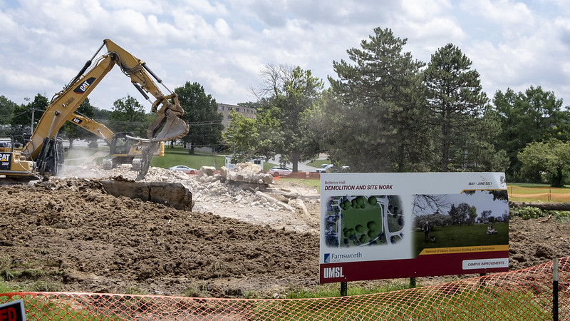 Yellow Crane Digging up dirt for building