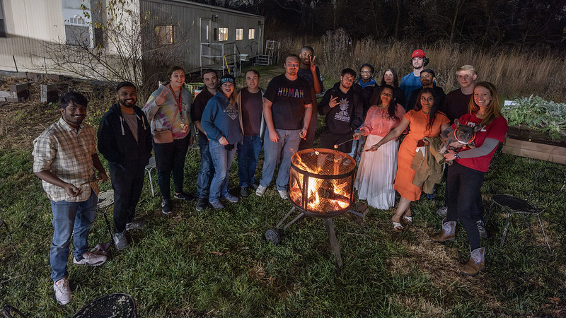 umsl sustainability bonfire with over a dozen happy people